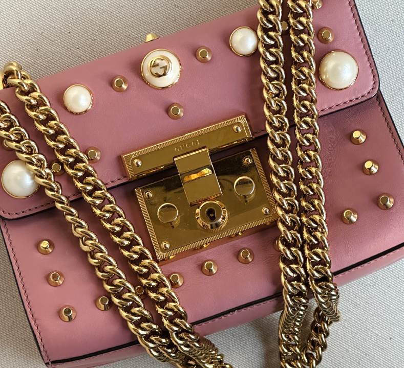 Foto de uma das bolsas gucci maximalistas com bordados de pérolas e tachas por toda a peçaa, modelo Padlock.