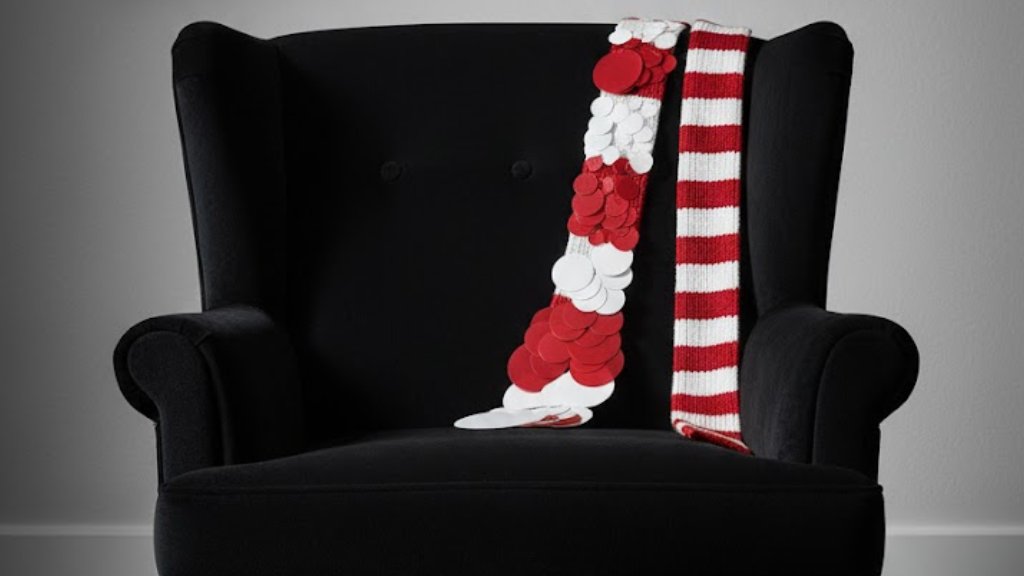 Foto de um dos acessórios Prada, um cachecol listrado feito em cashmere com paetes de tamanhos variaos.